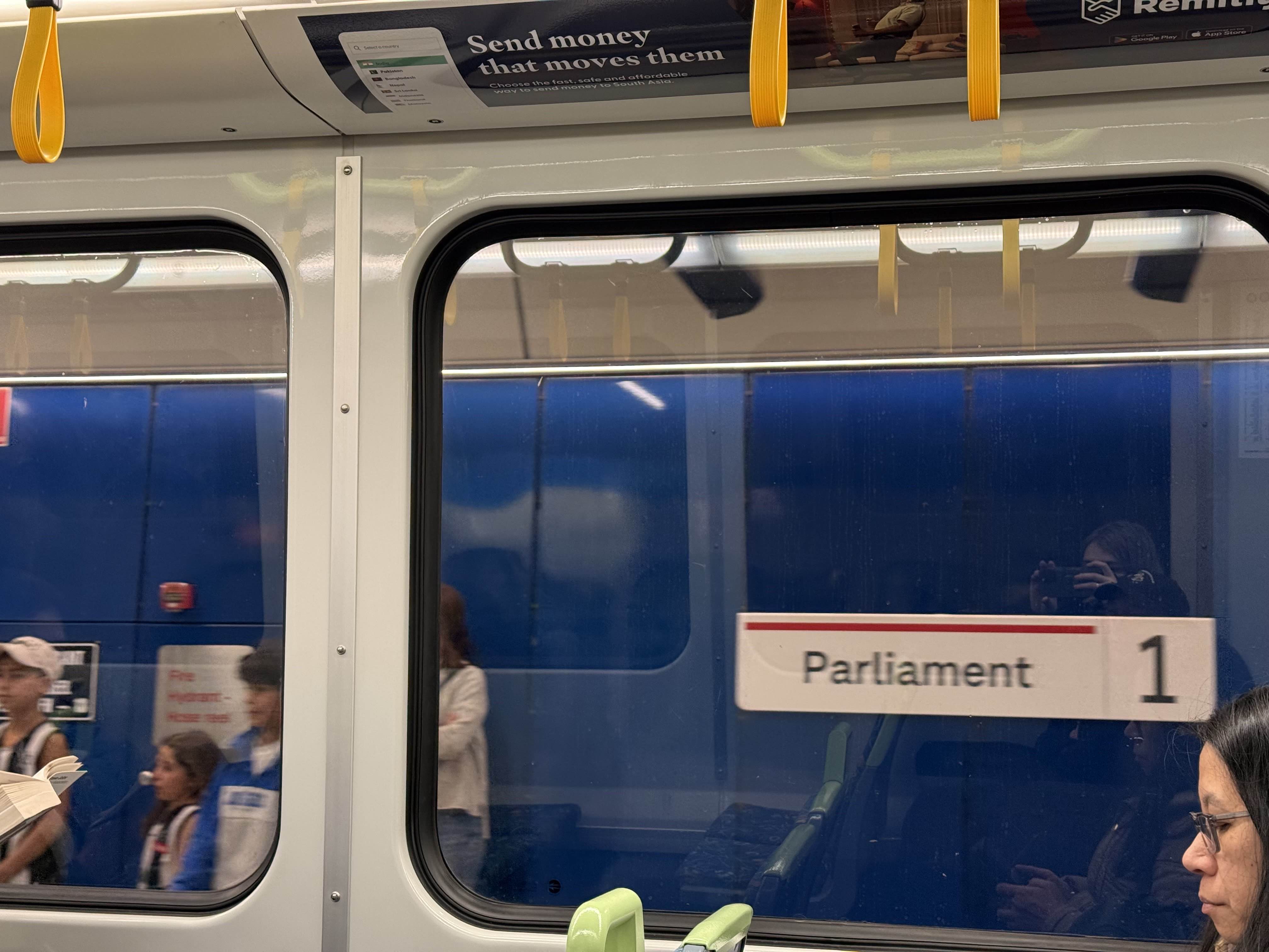 Picture of a sign on a platform at parliament station that reads parliament