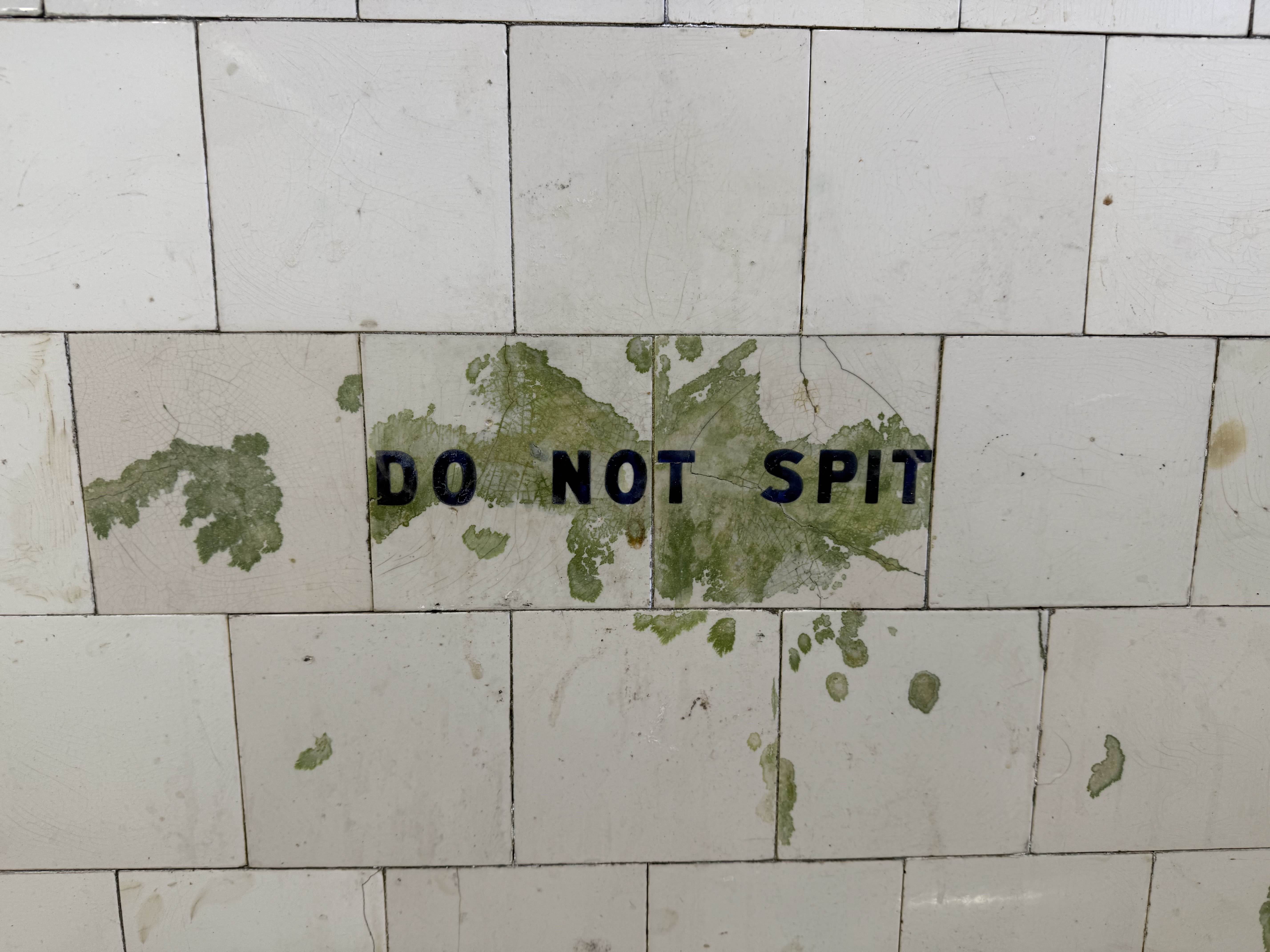 sign saying do not spit